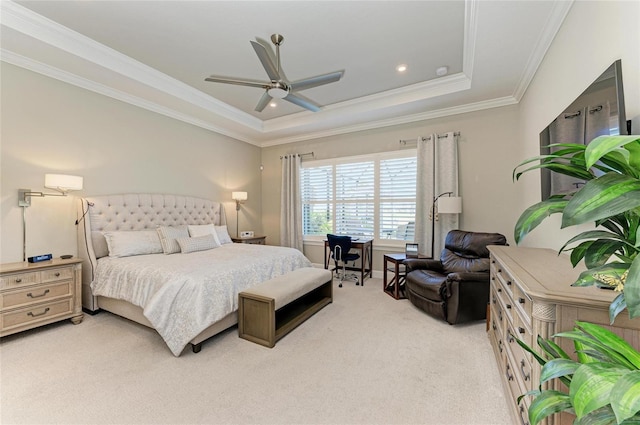 bedroom featuring a tray ceiling, ornamental molding, a ceiling fan, and light carpet
