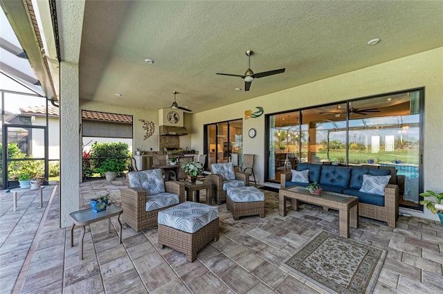 view of patio / terrace with an outdoor hangout area, a ceiling fan, and glass enclosure