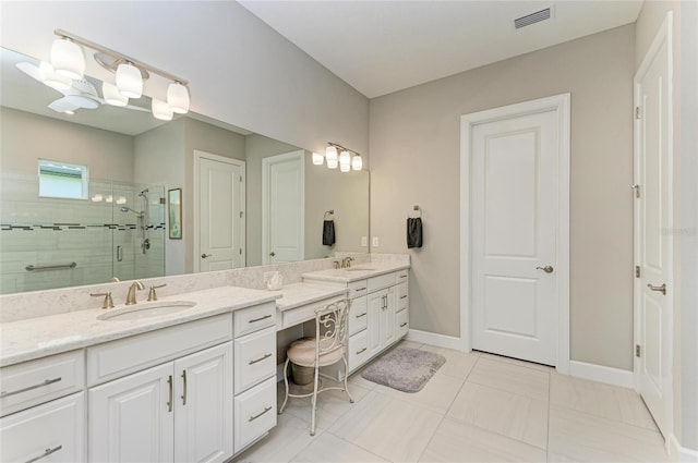 bathroom with visible vents, a stall shower, double vanity, and a sink