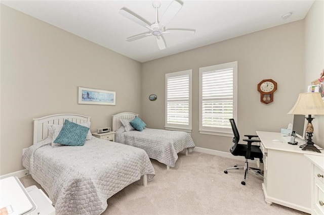 bedroom with light colored carpet, ceiling fan, and baseboards