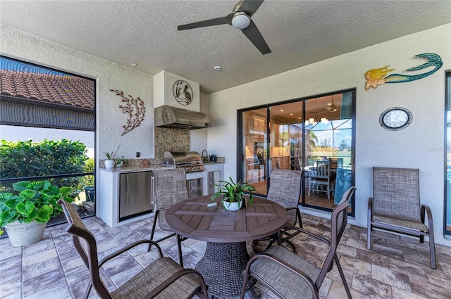 view of patio featuring outdoor dining space, area for grilling, and a ceiling fan