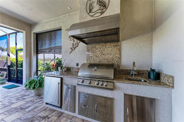 view of patio with an outdoor kitchen, a lanai, a sink, and a grill
