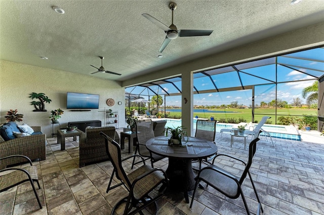 view of patio featuring outdoor lounge area, ceiling fan, a lanai, and an outdoor pool