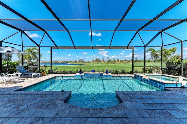 view of swimming pool with a pool with connected hot tub, a patio, and glass enclosure