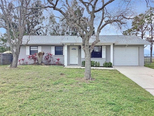 single story home featuring a garage and a front lawn