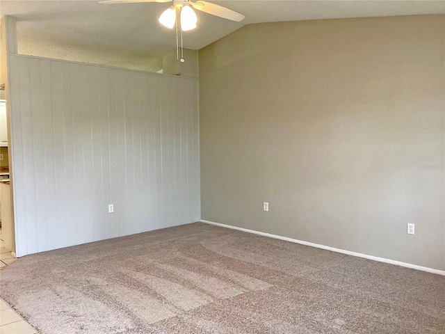 spare room featuring lofted ceiling, light colored carpet, and ceiling fan