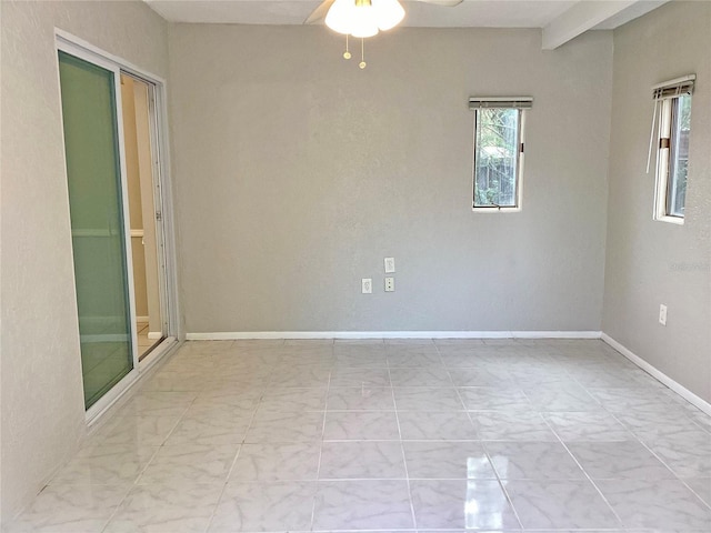 unfurnished room with beam ceiling