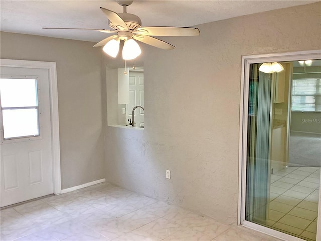 empty room with sink and ceiling fan