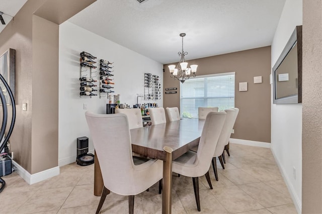 dining space with light tile patterned floors and a chandelier