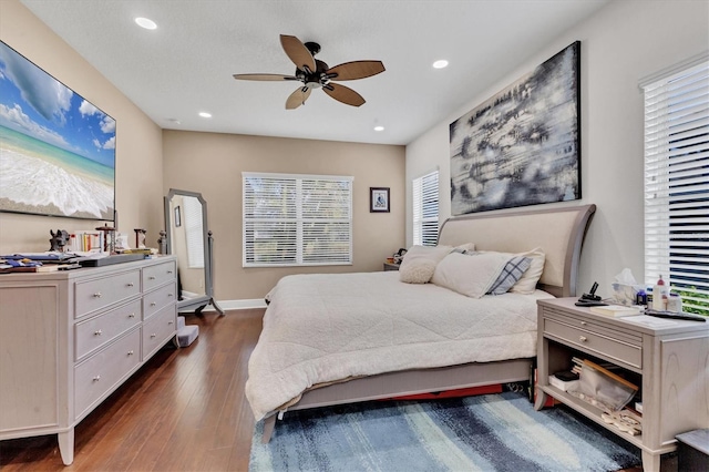 bedroom with dark hardwood / wood-style floors and ceiling fan