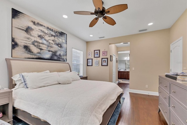 bedroom with ensuite bathroom, dark hardwood / wood-style floors, ceiling fan, and a baseboard radiator