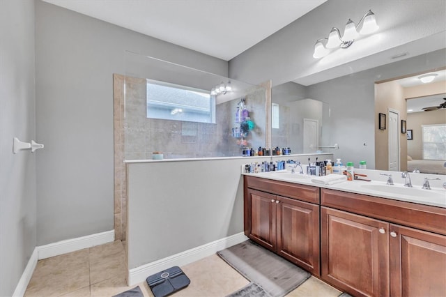 bathroom featuring vanity, a tile shower, and tile patterned floors