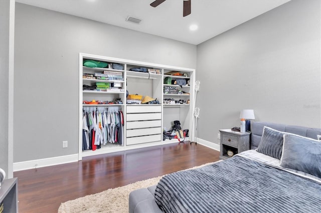 bedroom featuring dark hardwood / wood-style floors, ceiling fan, and a closet