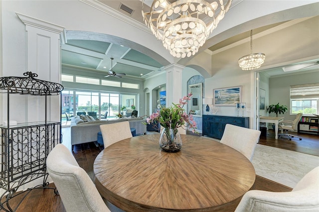 dining space featuring ornate columns, beamed ceiling, ornamental molding, coffered ceiling, and dark wood-type flooring