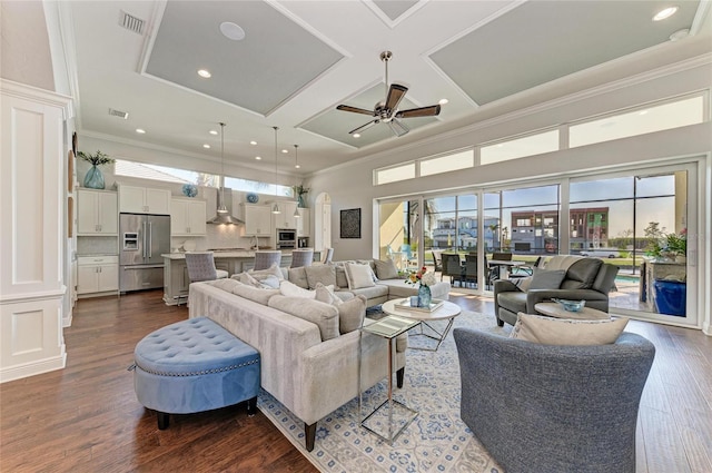 living room featuring dark hardwood / wood-style flooring, a high ceiling, coffered ceiling, ceiling fan, and crown molding