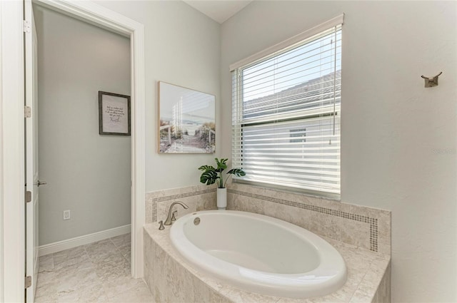 bathroom featuring tiled tub