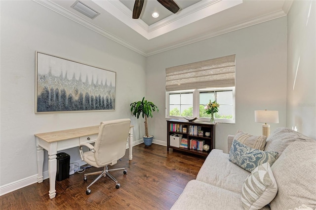 office area with ornamental molding, dark wood-type flooring, ceiling fan, and a tray ceiling