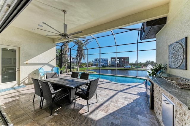 view of swimming pool featuring a lanai, a patio, ceiling fan, and a water view