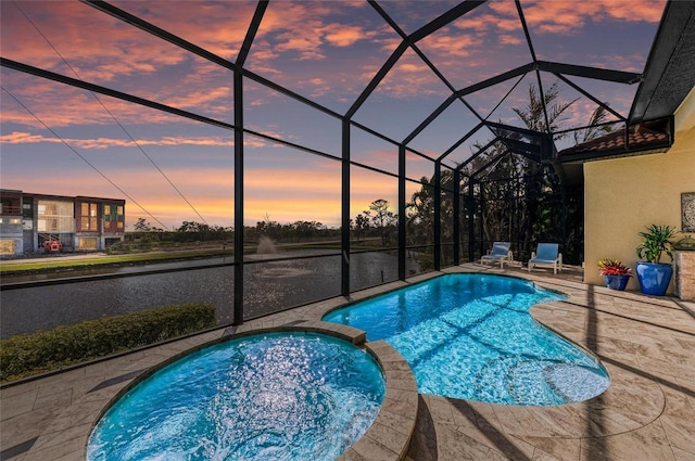 pool at dusk featuring a patio and glass enclosure