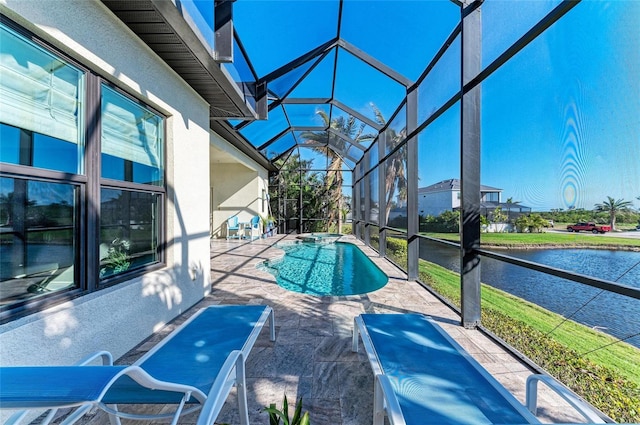 view of pool with a lanai, a water view, and a patio area