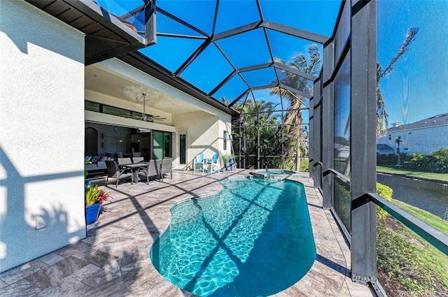 view of swimming pool featuring an in ground hot tub, ceiling fan, a lanai, and a patio area