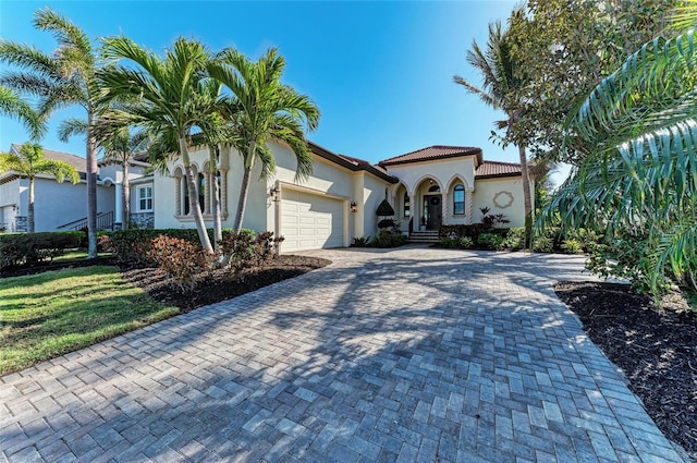 mediterranean / spanish house featuring a garage