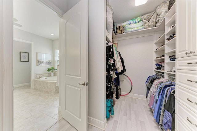 walk in closet featuring light hardwood / wood-style floors