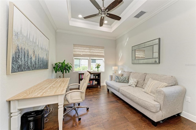 office space featuring dark hardwood / wood-style flooring, ornamental molding, a raised ceiling, and ceiling fan