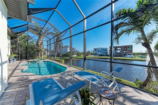 view of swimming pool with a water view, a patio, an in ground hot tub, and glass enclosure