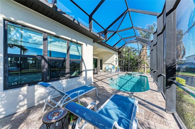 view of swimming pool featuring a lanai and a patio