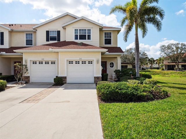 view of front facade featuring a garage and a front lawn