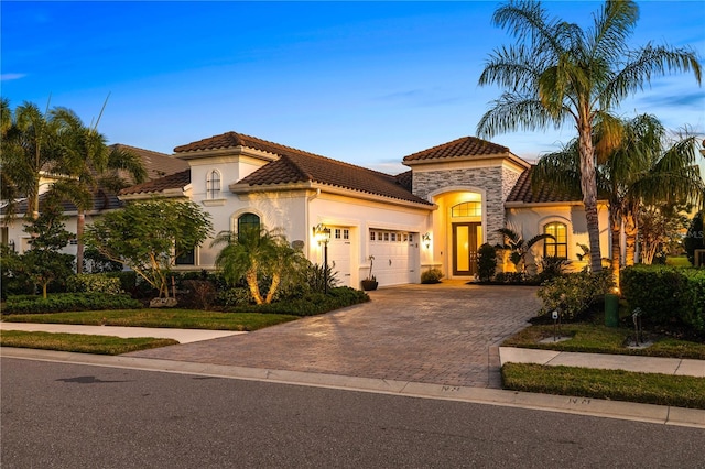 mediterranean / spanish-style home featuring a garage