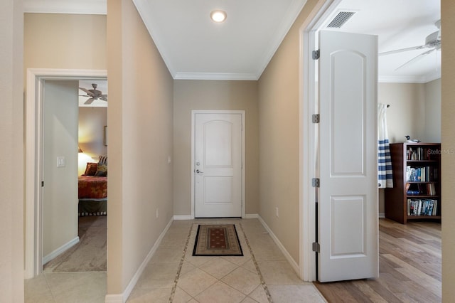 interior space featuring ceiling fan, ornamental molding, and light tile patterned floors