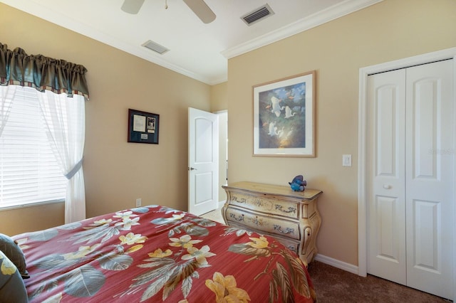 carpeted bedroom with crown molding, ceiling fan, and a closet