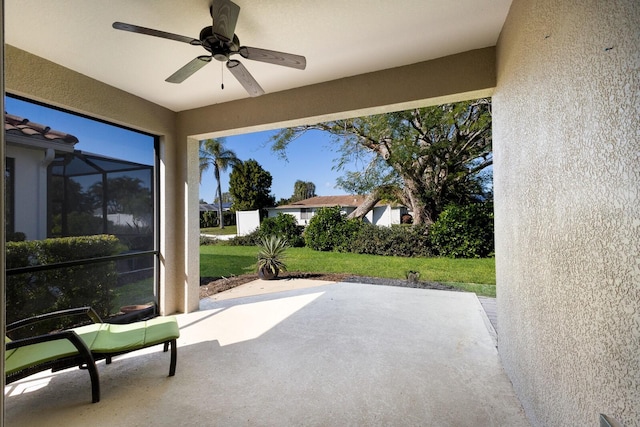 view of patio featuring a lanai and ceiling fan