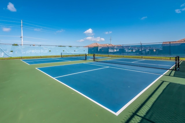 view of tennis court featuring basketball hoop