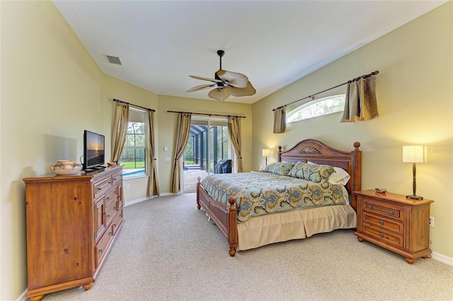 bedroom featuring a textured ceiling, access to outside, light colored carpet, and ceiling fan