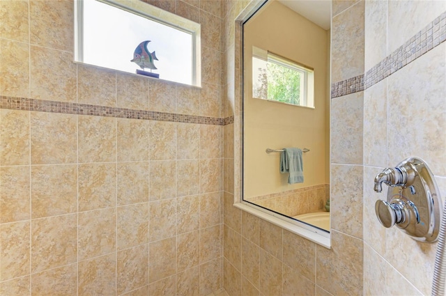 bathroom with a tile shower