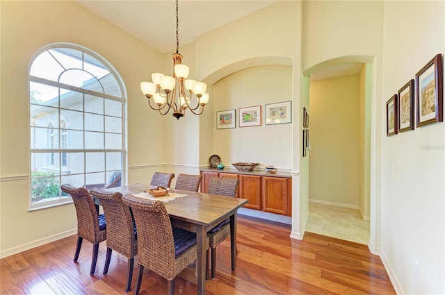 dining room with a chandelier and light wood-type flooring