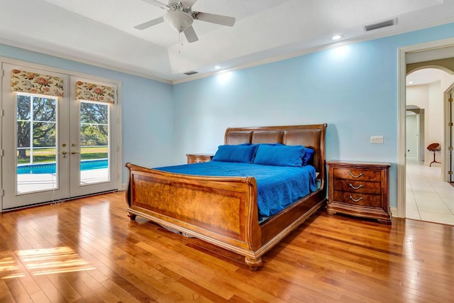 bedroom with french doors, ornamental molding, light hardwood / wood-style flooring, and access to outside