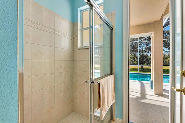 bathroom featuring a shower with shower door