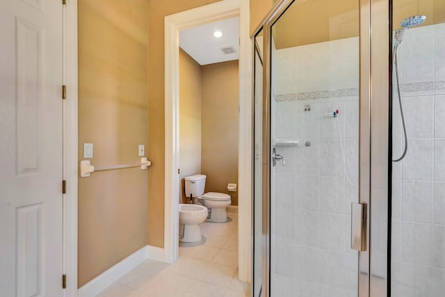 bathroom featuring a bidet, tile patterned floors, a shower with door, and toilet