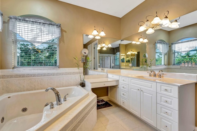 bathroom with vanity, a relaxing tiled tub, and tile patterned floors