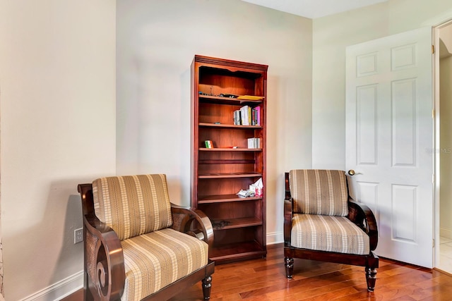 sitting room with hardwood / wood-style flooring