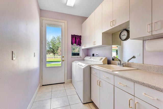 washroom with cabinets, separate washer and dryer, sink, and light tile patterned floors