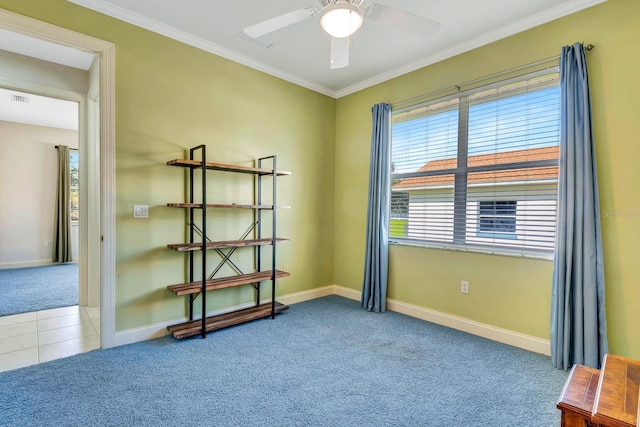 empty room featuring crown molding, light colored carpet, and ceiling fan