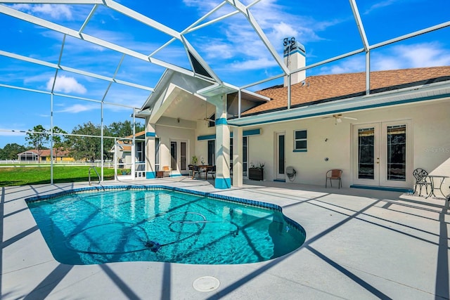 view of pool featuring french doors, ceiling fan, a lanai, and a patio area