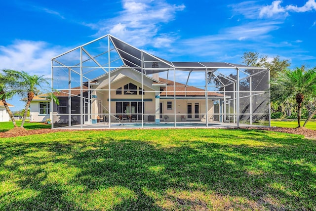 back of property with a yard, a lanai, and a patio