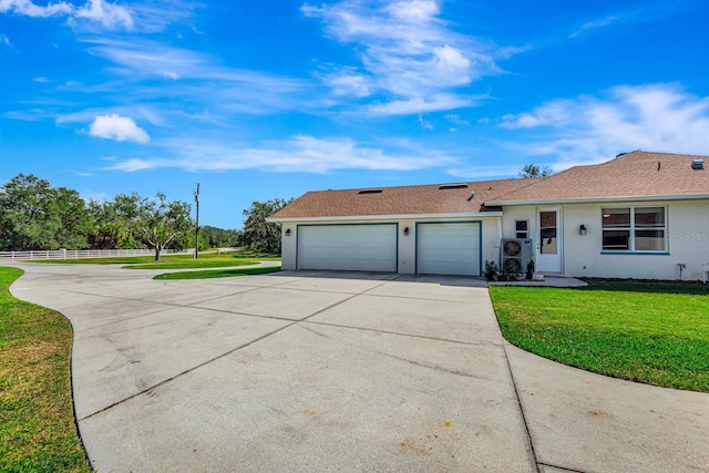 single story home featuring a garage and a front yard