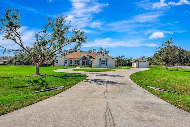 single story home featuring a garage and a front lawn